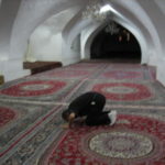 ジャーメ・モスク　西礼拝堂半地下のシャベスタン。　メッカは前方だが礼拝の仕方が分かるように横向きになって祈るガイドさん